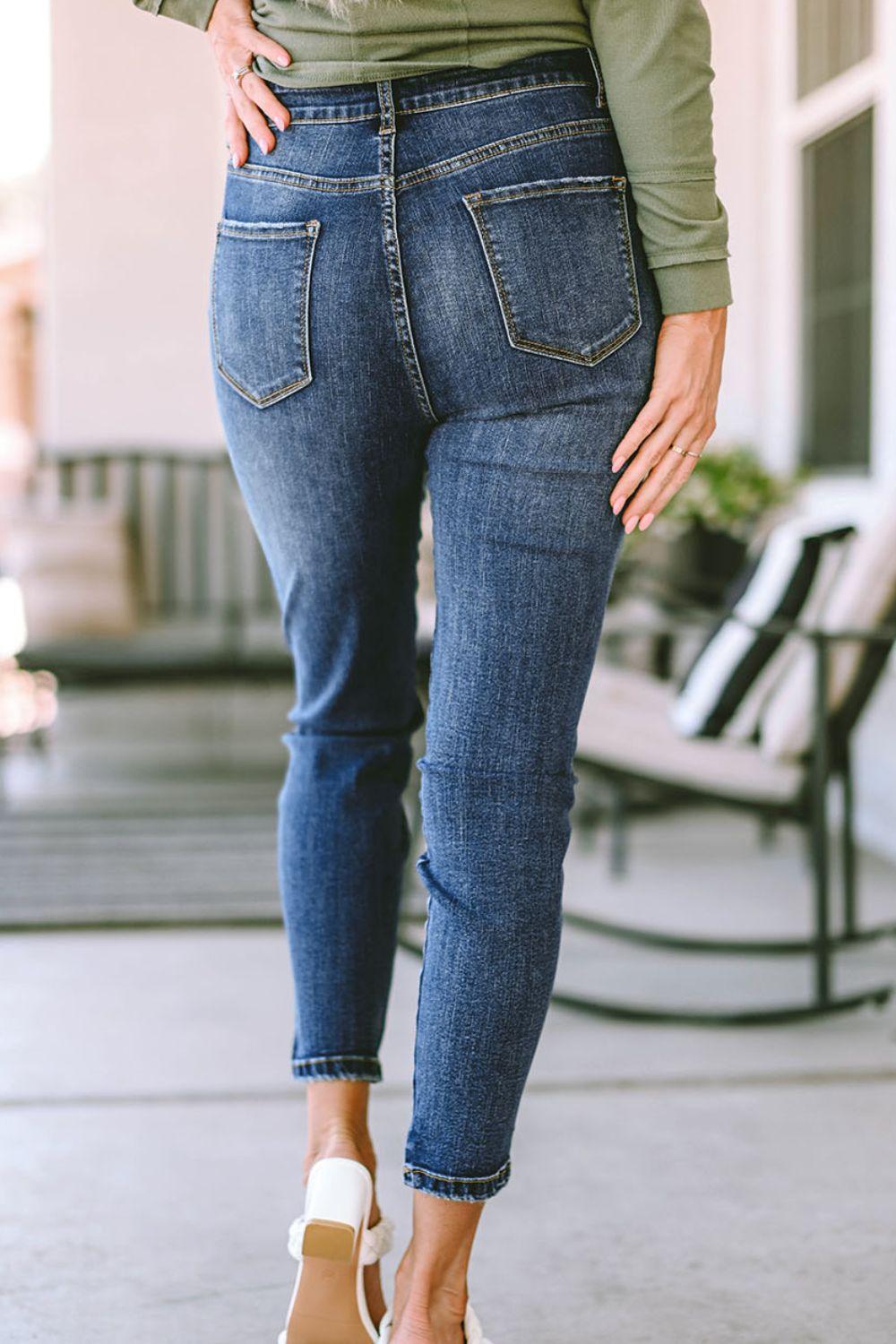 a woman in a green shirt and jeans