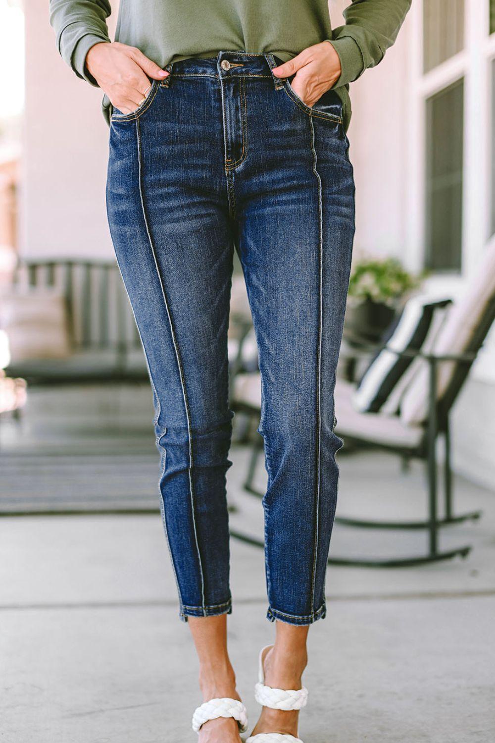 a woman wearing a green sweater and jeans