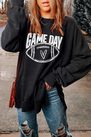 a woman wearing a game day sweatshirt and ripped jeans