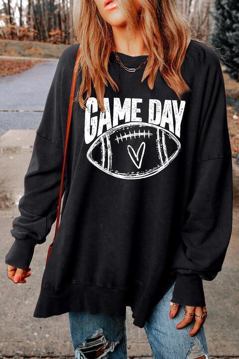 a woman wearing a black game day sweatshirt