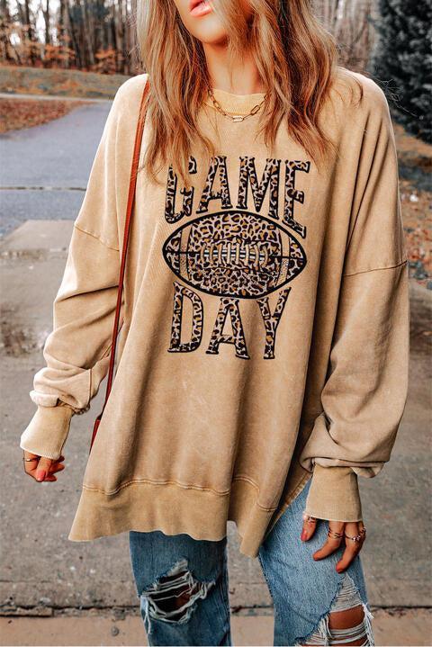 a woman wearing a sweatshirt that says game day