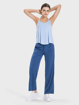 a woman in a blue tank top and blue pants