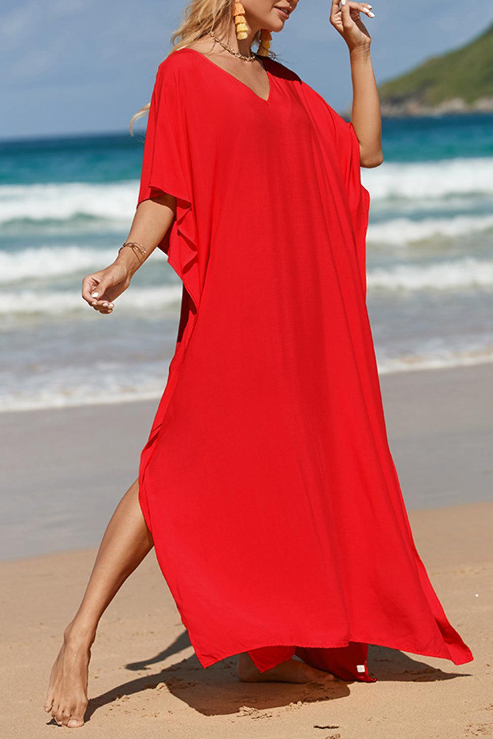 a woman in a red dress on the beach