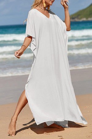 a woman in a white dress on the beach