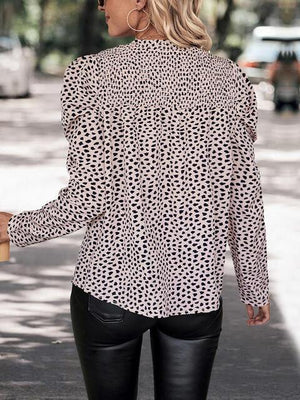 a woman in black leather pants and a leopard print shirt