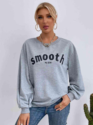 a woman wearing a gray sweatshirt with the words smooth on it