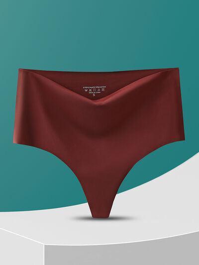 a woman's panties on a pedestal with a teal background
