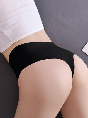 a woman in a black panties laying on a bed