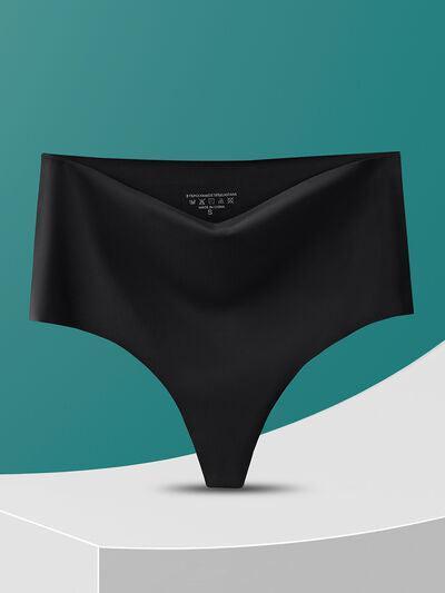 a woman's black panties on a green and white background