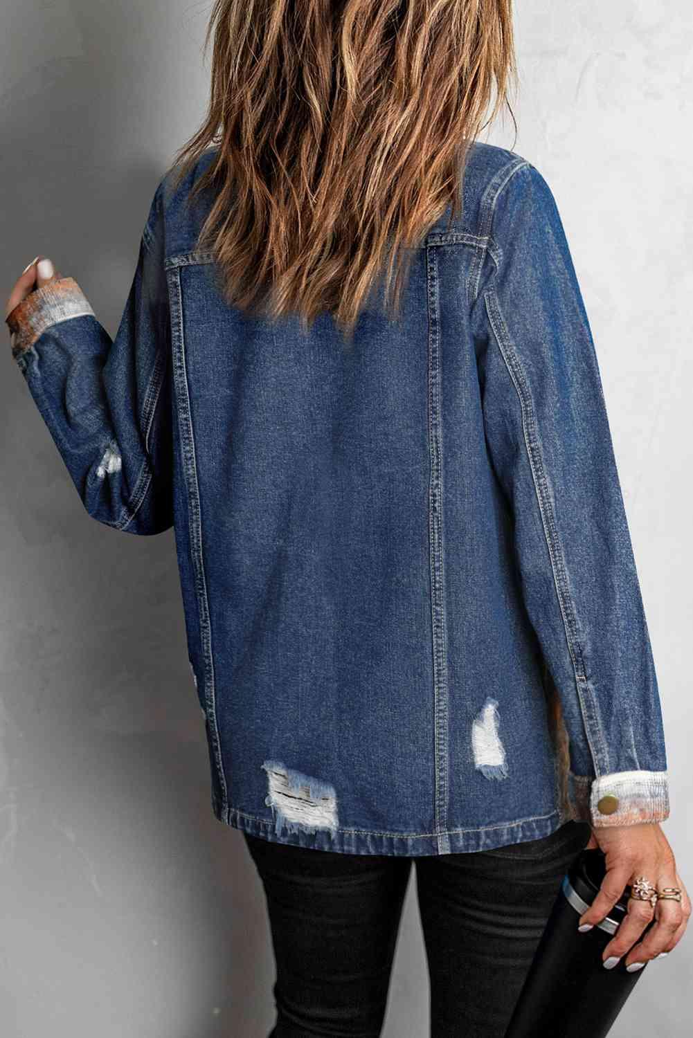 a woman with long hair wearing a jean jacket