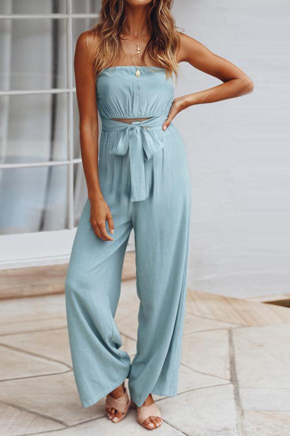 a woman wearing a blue strapless jumpsuit