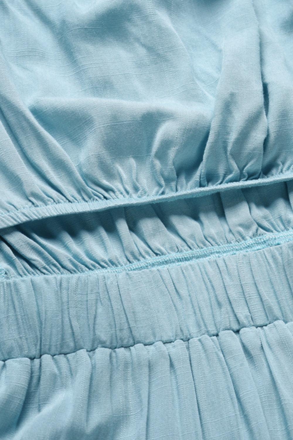 a close up of a blue dress with ruffles