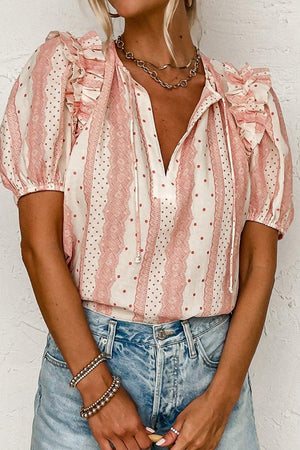 a woman wearing a pink and white striped blouse