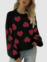 a woman wearing a black sweater with red hearts on it