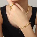 a woman wearing a black shirt and a gold chain bracelet