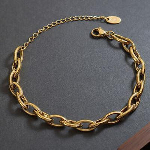 a close up of a gold bracelet on a table