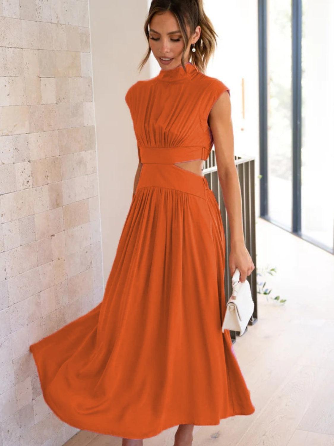 a woman in an orange dress is holding a purse