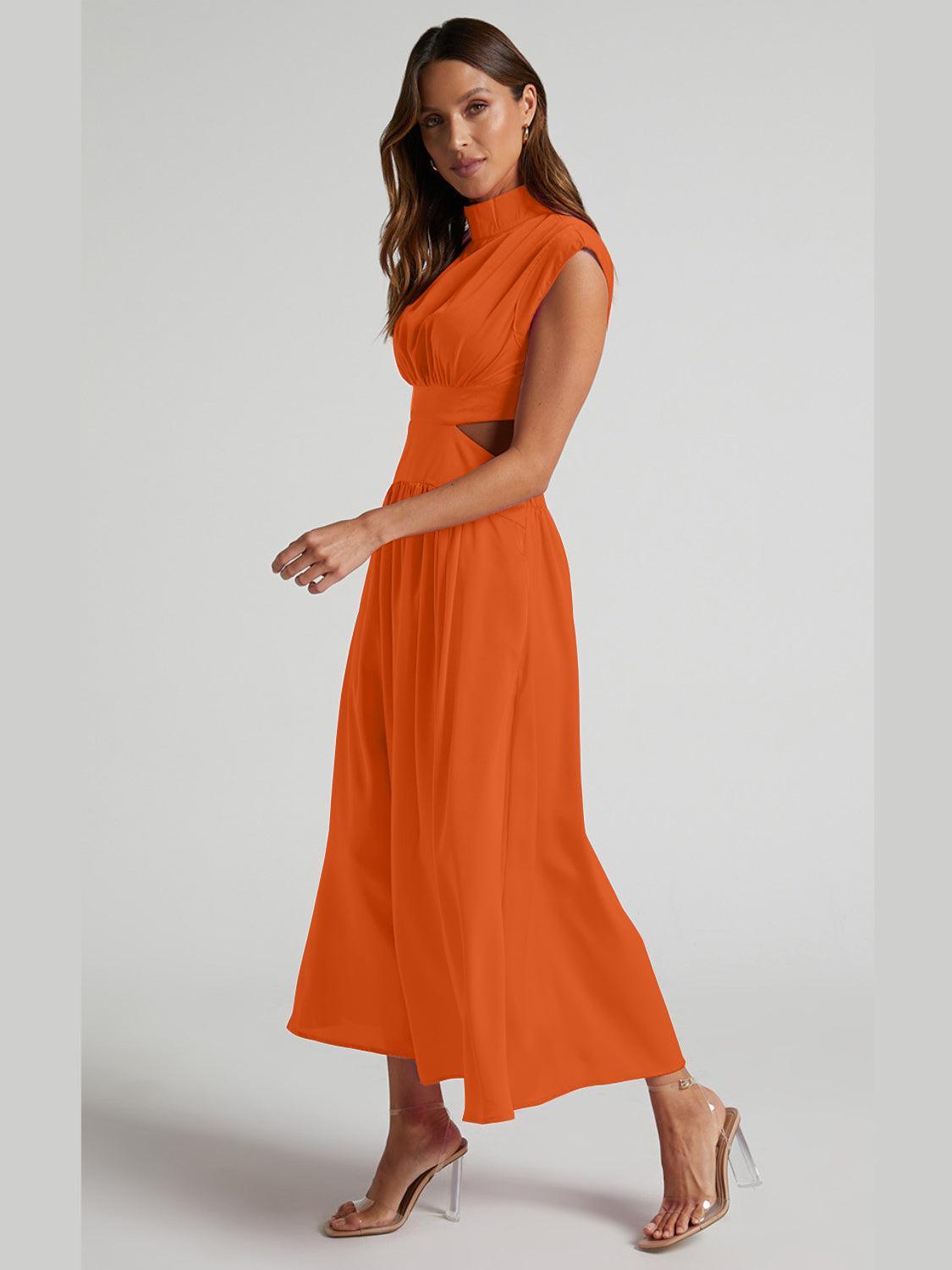 a woman in an orange dress poses for a picture