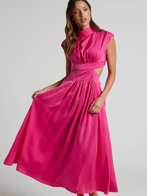 a woman in a pink dress posing for a picture