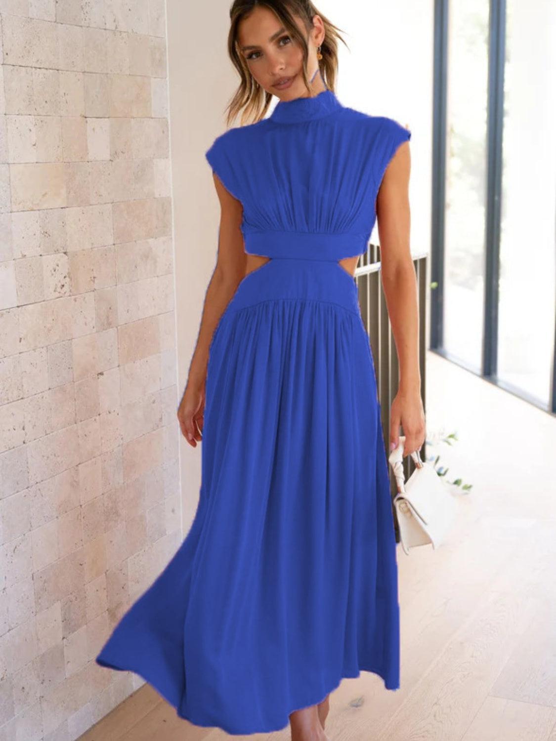 a woman in a blue dress posing for a picture