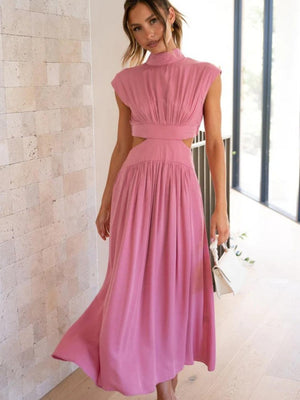 a woman wearing a pink dress and heels