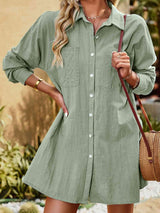 a woman wearing a green shirt dress