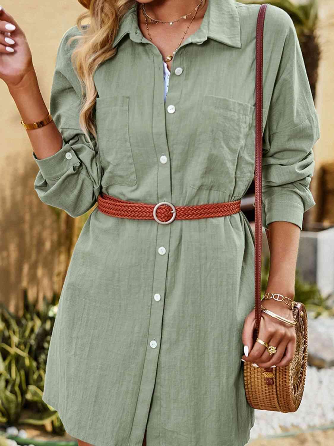 a woman wearing a green shirt dress and a straw hat