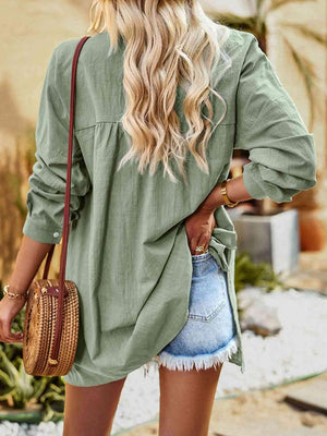 a woman wearing a green shirt and denim shorts