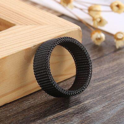 a black ring sitting on top of a wooden table