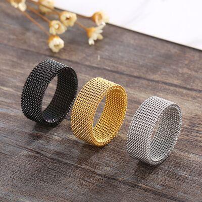 three different colored rings sitting on top of a wooden table