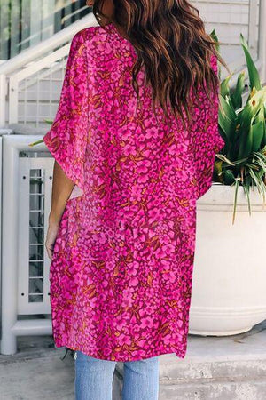 a woman wearing a pink floral print top