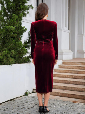 a woman in a red velvet dress standing on steps