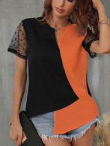 a woman wearing a black and orange top