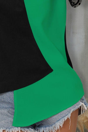 a woman wearing a green and black top