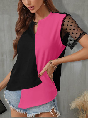 a woman wearing a pink and black top