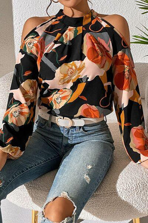 a woman sitting on a chair wearing ripped jeans