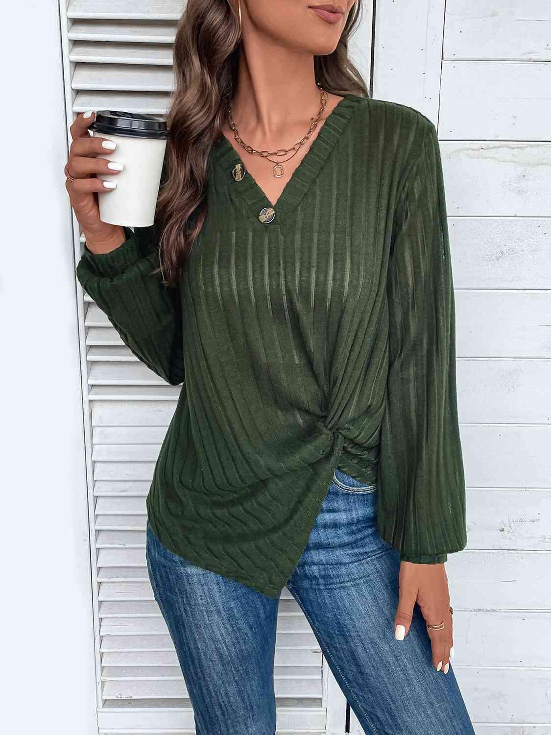 a woman in a green top holding a cup of coffee