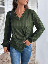 a woman wearing a green top and jeans