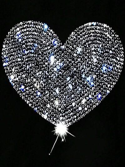 a heart - shaped object is lit up in the dark