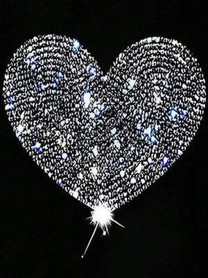 a heart - shaped object is lit up in the dark