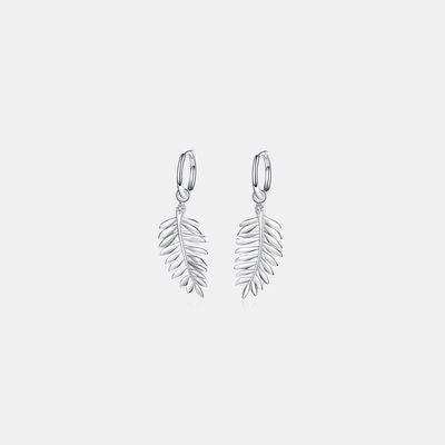 a pair of earrings with a leaf design