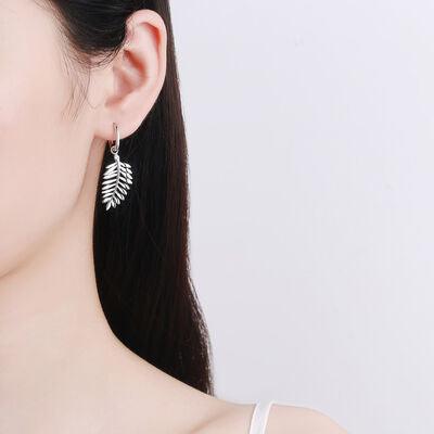 a close up of a person wearing a pair of earrings