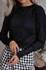 a woman wearing a black sweater and checkered skirt