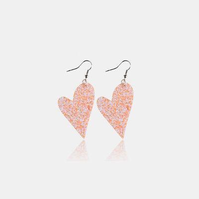 a pair of pink glitter heart shaped earrings