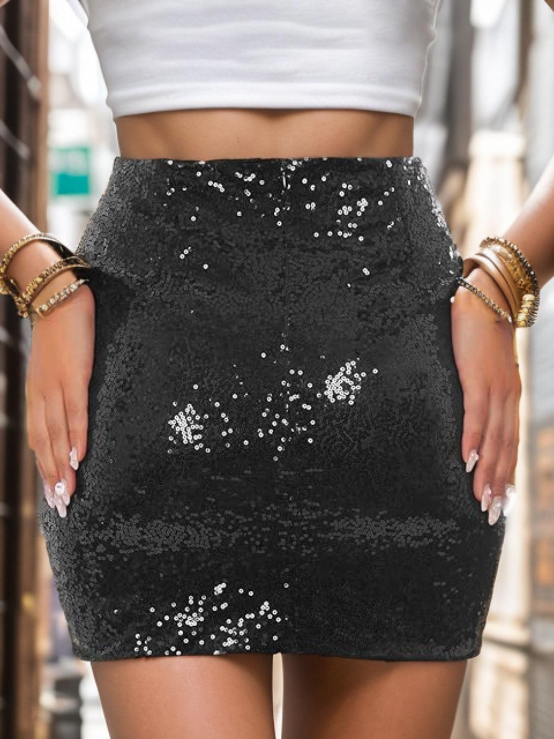 a woman in a white top and black sequin skirt