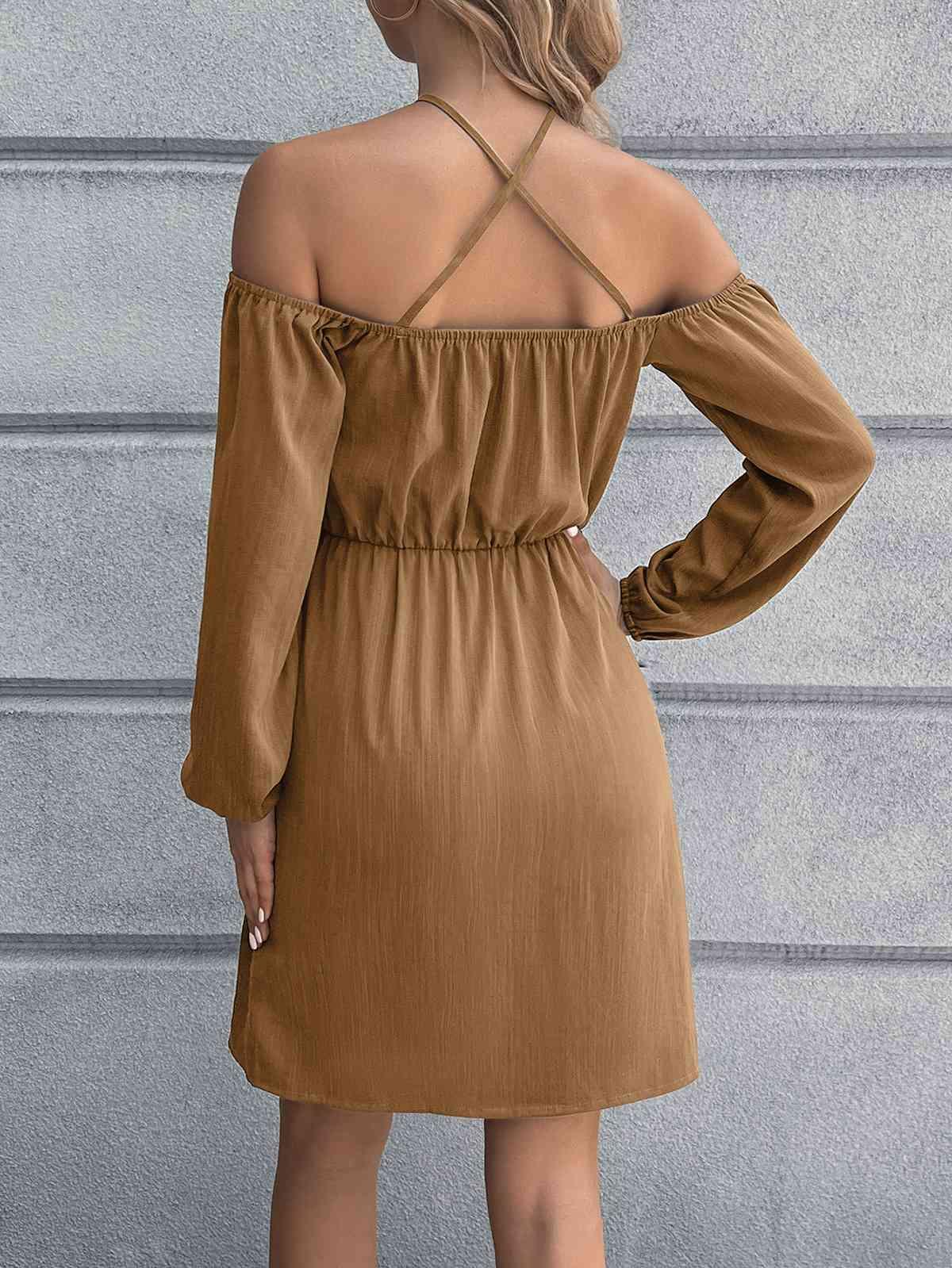 a woman wearing a brown dress with a cross back