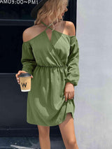 a woman in a green dress holding a cup of coffee