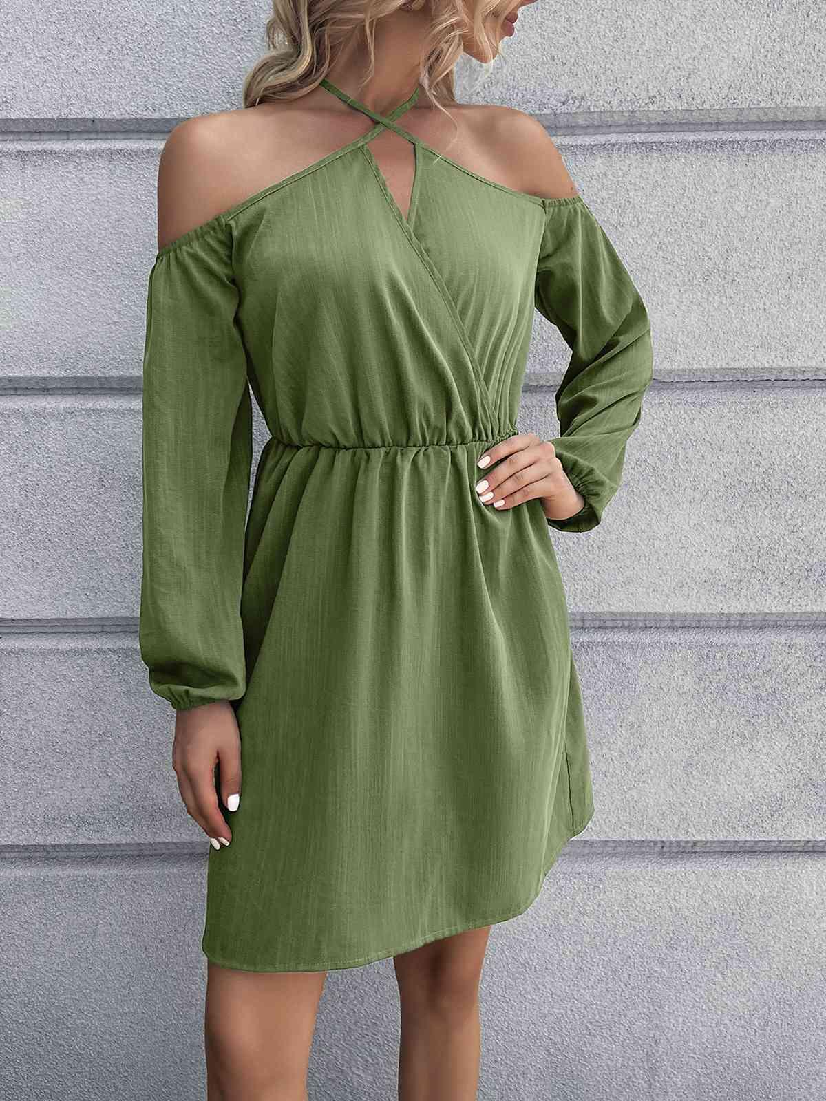 a woman in a green dress posing for the camera