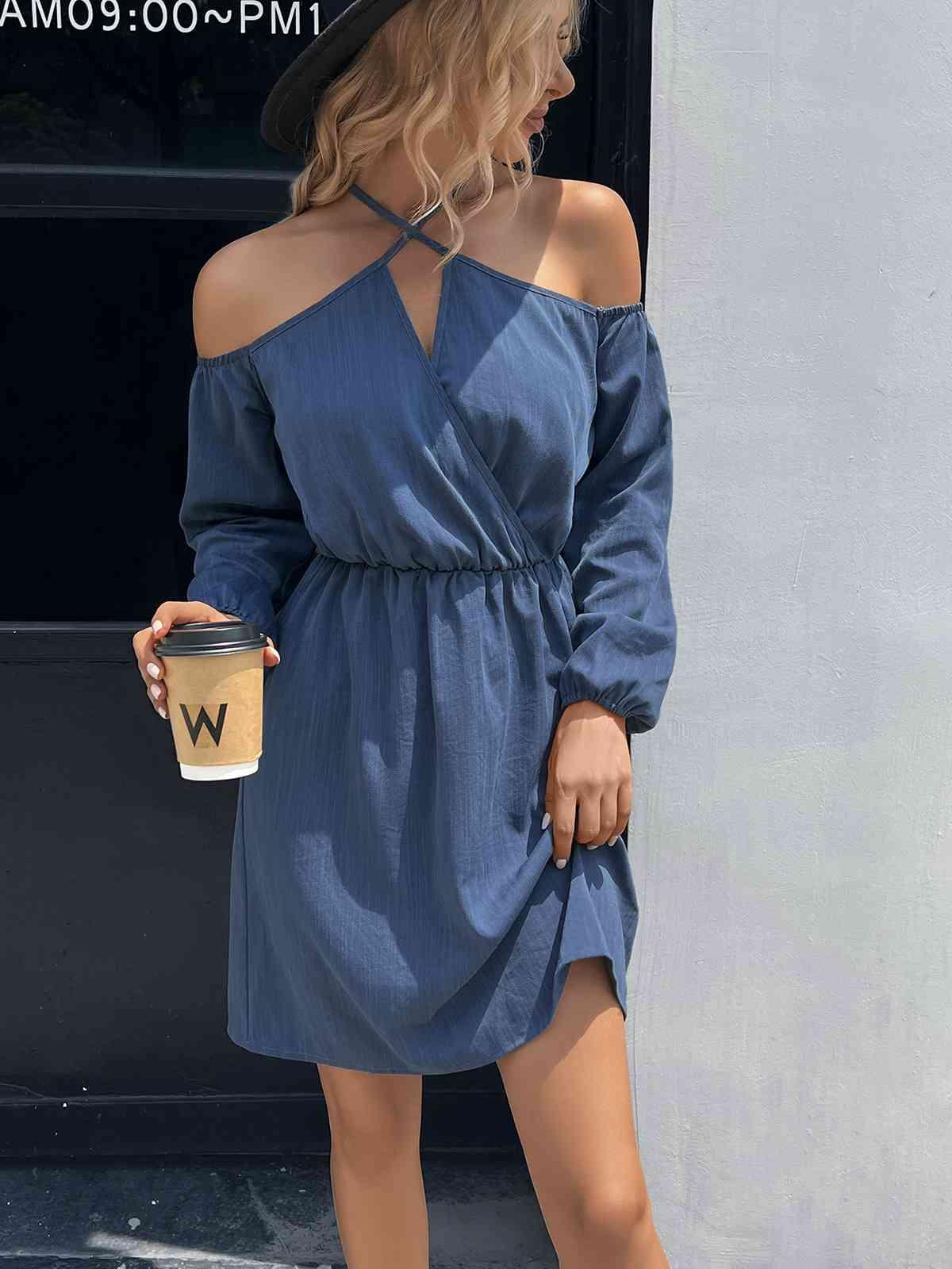 a woman in a blue dress holding a cup of coffee