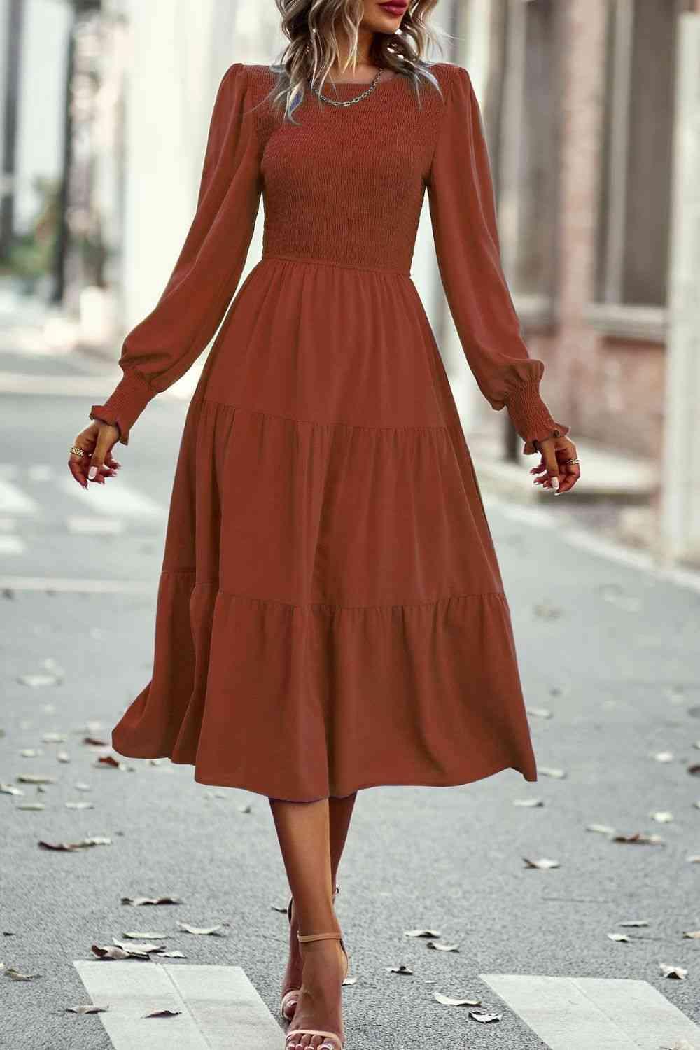 a woman in a brown dress is walking down the street